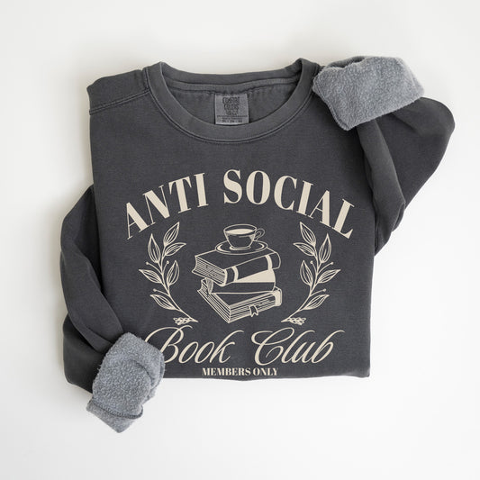 A folded unisex Comfort Colors sweatshirt in pepper color, featuring 'Anti Social Book Club - Members Only' text and book stack design in cream color