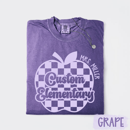 Purple t-shirt with a white apple design and text on a light purple background