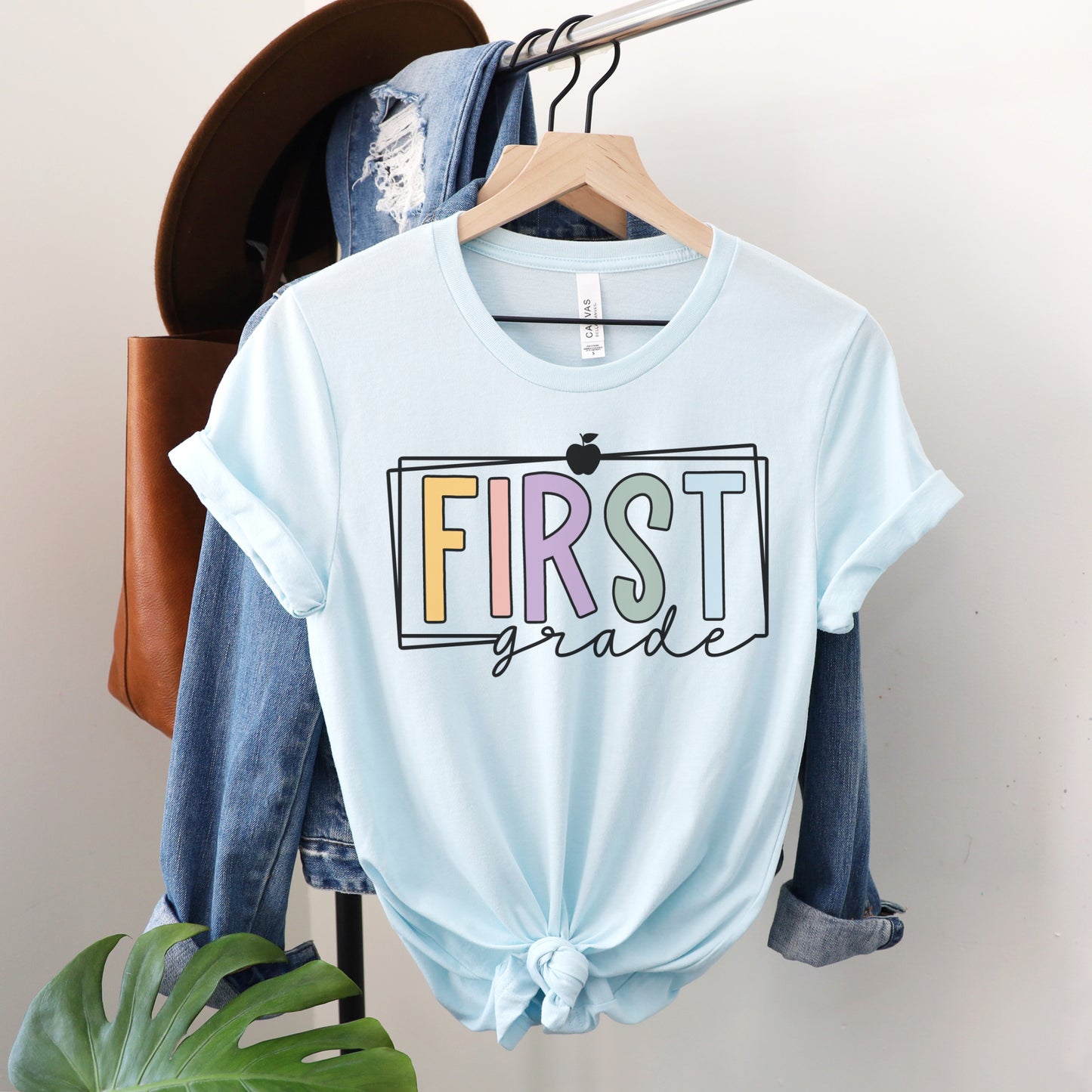 First Grade Teacher Multi Color Apple and Border Tshirt Heather Ice Blue