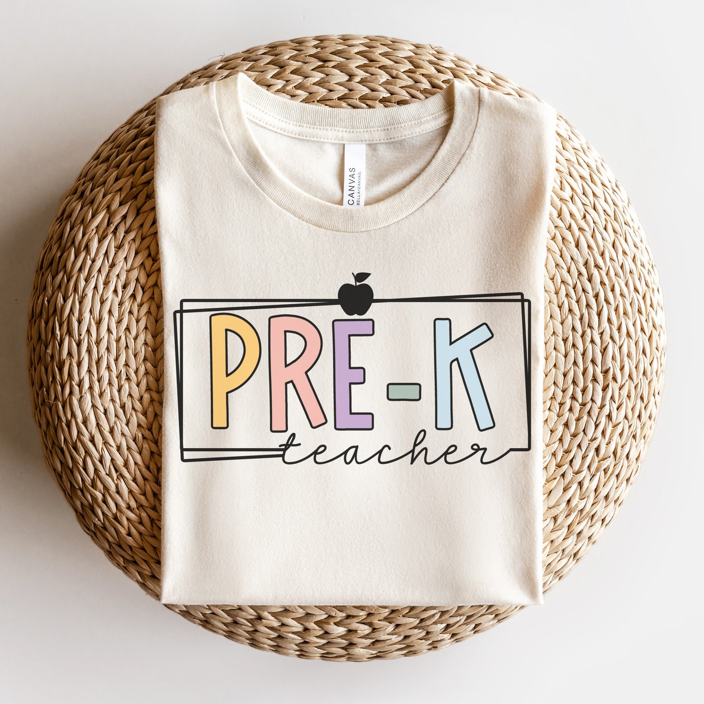 Pre-K teacher tshirt with multicolor font. White rectangle border and apple. Natural Color