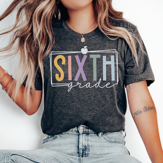 sixth grade teacher shirt multicolored vibrant font with white rectangle borders and apple dark grey heather color